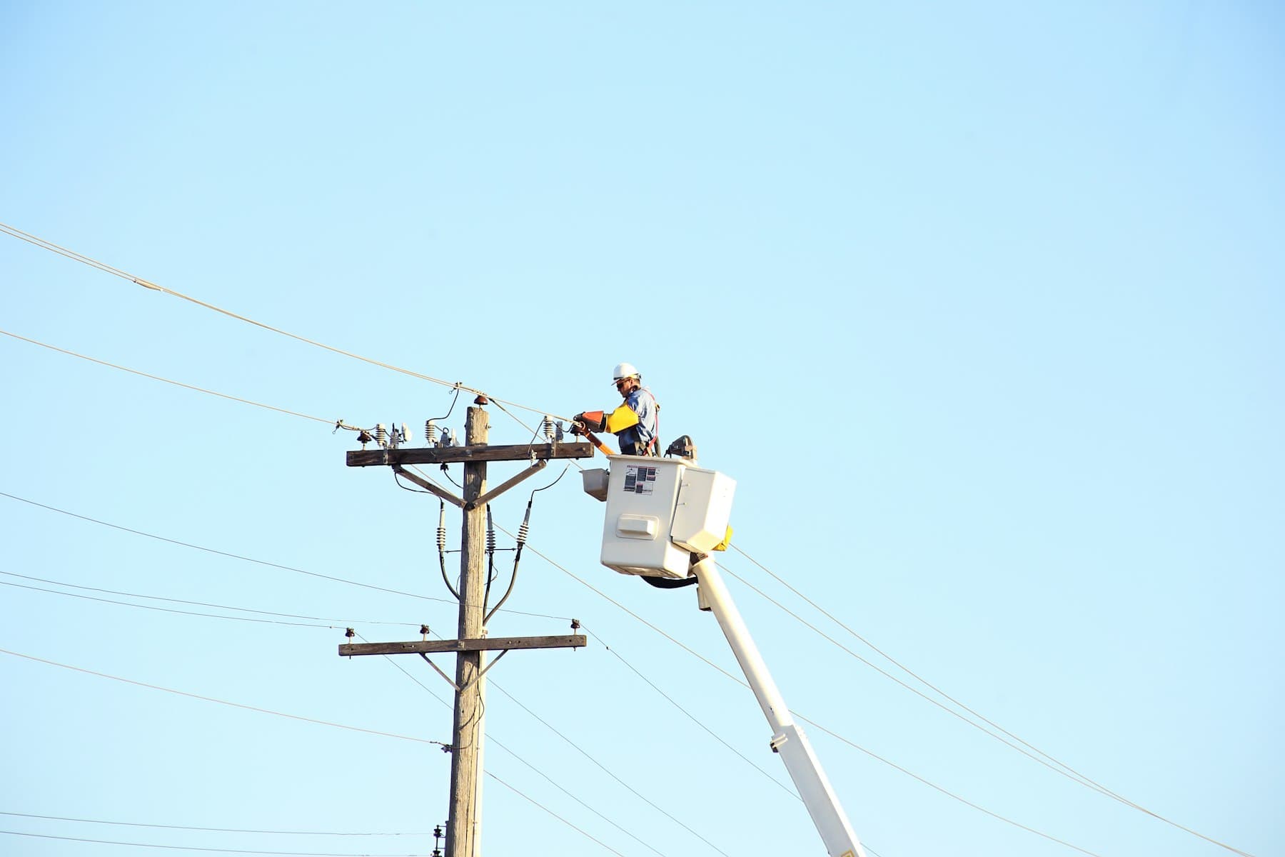 Lineman in a bucket working a crossarm